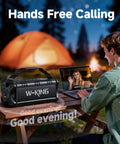 90W Peak Portable Bluetooth Speaker With Beastly Bass Subwoofers And Punchy HD Sound next to a person video calling at a campsite.