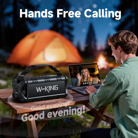 90W Peak Portable Bluetooth Speaker With Beastly Bass Subwoofers And Punchy HD Sound next to a person video calling at a campsite.