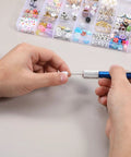 Hands using pin vise with 21 Piece Metric Mini Drill Bit Set for jewelry DIY near bead organizer