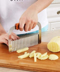 Murtenze stainless steel crinkle cutter with wooden handle, angled side view for slicing potatoes into wavy fries.