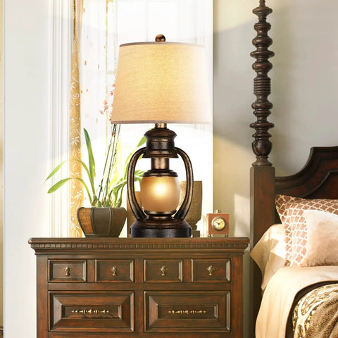 Rustic Lantern Table Lamp For Living Room And Bedroom End Table With Oatmeal Tapered Drum Shade, Built In USB Ports And AC Outlet on nightstand