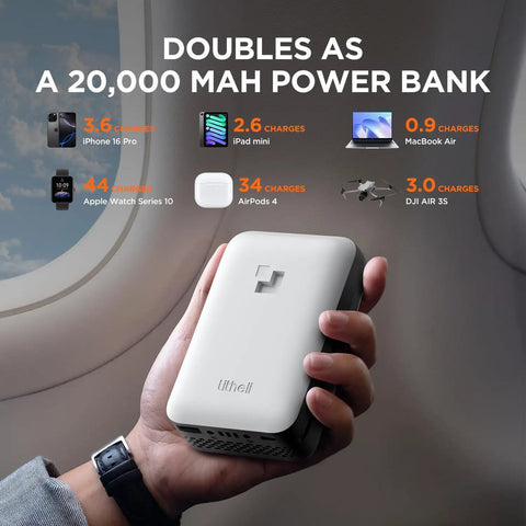 Person holding Lifesill power bank next to airplane window with charging stats for various devices on screen.