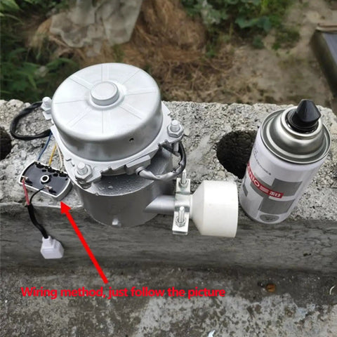 Portable 1000W 110V Water Turbine Generator on concrete block with wiring instructions and adjacent spray can