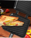 Kickstart Your Morning With This Dual-Sided Electric Mini Griddle And Waffle Maker Featuring A Non-stick Coating, Ergonomic Handle For Easy Grip, And Even Heat Distribution. Perfect Pancakes, Eggs, Or Grill veggies In No Time With Versatile Kitchen showing toasted sandwich with fillings on non-stick plates.