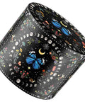Intricate black container with butterfly and moon designs on its surface
