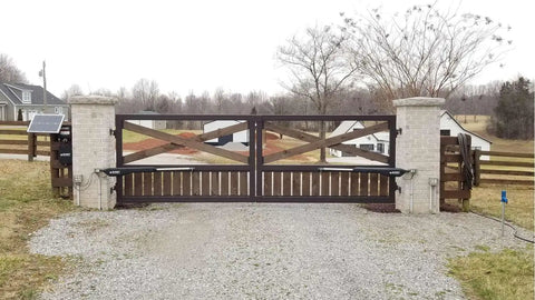 Dual Dope Smart Ready Automatic Gate Kit For Swing Gates Up To 1000 Pounds Or 12 Feet Per Gate installed on wooden driveway gate