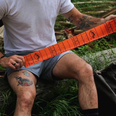 Duct-Aid medical tape, side view, orange roll being unspooled for first aid.