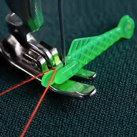 Green fish-type needle threader in use, threading a needle on a sewing machine. Five Piece Fish Type Needle Threaders for Sewing Machines and Hand Sewing.