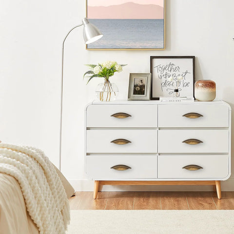 White dresser with Six Pack Antique Brass Cabinet Pulls Made From Zinc Alloy For Kitchen Drawers Dressers And Cupboards With Five And One Eighth Inch Total Length And Two And A Half Inch Center To Center Screw Spacing For Easy Installation And An Elegant Vintage Look in modern bedroom decor.