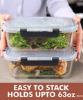 Hands holding Big Glass Storage Set 63 Oz Meal Prep Containers with Locking Lids, stacked with salad and chicken, 2-pack.