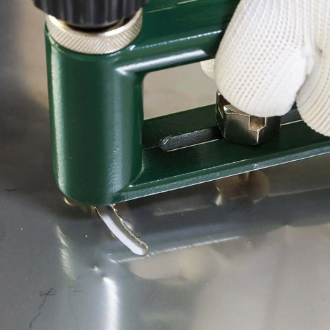 Adjustable Circle Hole Cutter for Sheet Metal 2 to 12 Inch cutting through metal with drill, close-up of action with glove