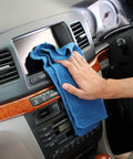 Person cleaning car dashboard with 90 Pack Blue Cotton Shop Towels 14 By 12 Inches Reusable Rags For Auto Garage Industrial And Home Cleaning Absorbent Cloths For Tough Messes And Heavy Duty Jobs Pre Wash In Warm Water Recommended.