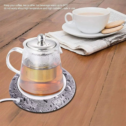 Smart Usb Coffee Mug Warmer And Electric Beverage Heater For Desk Use keeps a tea pot warm on a wooden table, safe up to 80°C.