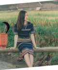 Heavy Duty Manganese Steel Garden Scythe With Long Handle for Weeding displayed beside a person sitting on a log in a garden