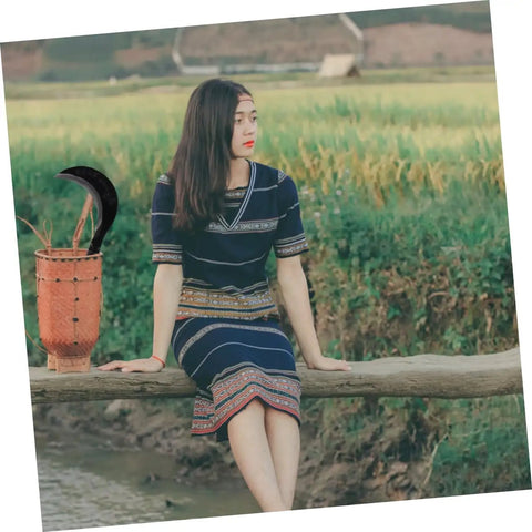Heavy Duty Manganese Steel Garden Scythe With Long Handle for Weeding displayed beside a person sitting on a log in a garden