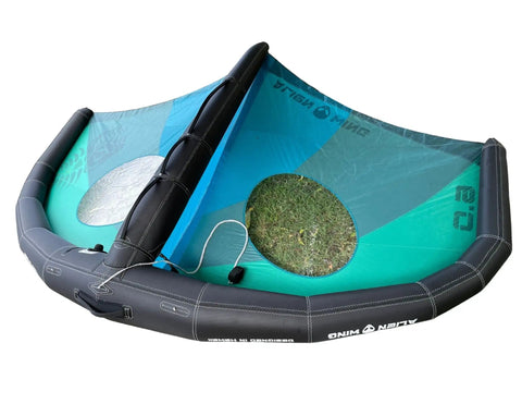 Alien Wing 6M High Performance Wind Wing for foiling and surfing, rigid airframe, tri-color design, with backpack and wrist leash.