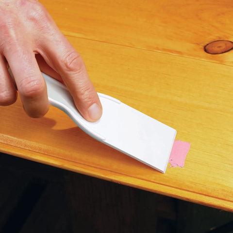 Applying Plastic Wood Filler with DryDex Dry Time Indicator on wood surface using a scraper, natural color visible