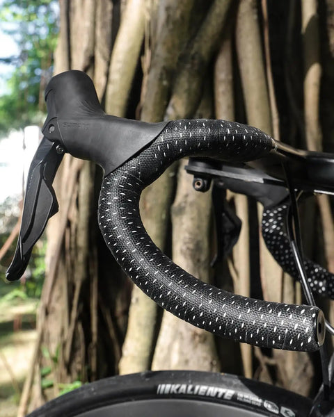 Road Bike Handlebar Tape With Silicone Surface For A Sticky Sweatproof Grippy Feel EVA Comfort Shock Absorbing Non Slip Tape Stain Resistant Finish Includes Aluminum Bar Plugs Set Of 2 In Black on bike outdoors