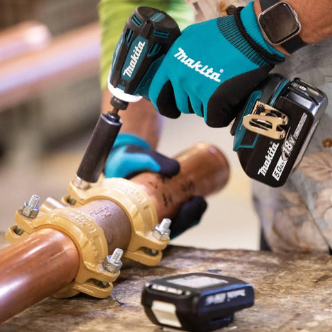 Person using 18V LXT Brushless Cordless Hammer Drill And Impact Driver Combo Kit With 5.0Ah Batteries on a copper pipe