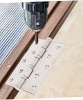 Stainless steel door hinge, two-piece design, being drilled into wood during installation