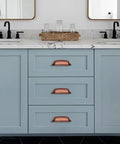 Antique Copper Cabinet Knobs 10 Pack Center Mount 1-1/4 Inch Zinc Vintage Retro Drawer and Kitchen Cabinet Pull Hardware installed on blue vanity