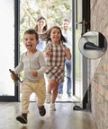 Four Pack Premium Rubber Door Stoppers Wedge Set for Carpet Tile Concrete and Wood Floors, used in a busy home entrance.