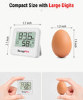 Bluetooth Digital Hygrometer Indoor Thermometer With 260 Ft Range And Comfort Icons No Fuss Dry Comfort Wet For Quick Humidity And Temperature Readouts At Home Or Office. Compact 2.2 inch white digital hygrometer next to egg for size comparison