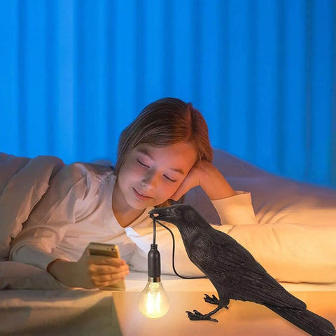 Raven Desk Lamp Dope Resin LED Bird Light casting ambient glow in bedroom, crow detail with bulb, child reading