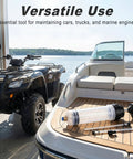 Professional Heavy Duty Manual Oil Extractor Pump With Slick No Drip Suction 200CC Dual Pvc Hoses on a boat with ATV in background.