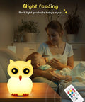 Kids Night Light With Remote, 7 Color Kawaii Cat Nursery Lamp illuminating a bedroom, USB rechargeable, mother feeding baby.