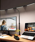 Lit Ultra Bright 4-Head LED Desk Lamp With Clamp illuminating wide 90-inch desk workspace with computer and monitor setup.