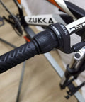 Close-up of bike handlebar with 21 Speed Twist Shifter Lever Kit For Bikes 3 By 7 Gear Grip Shift in black grip on mountain bike.