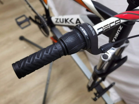 Close-up of bike handlebar with 21 Speed Twist Shifter Lever Kit For Bikes 3 By 7 Gear Grip Shift in black grip on mountain bike.