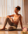 Mini Crystal Table Lamp With Warm Soft LED Light For Home Decor Eye Friendly Night Light Chic Natural Crystal Accent To Create A Cozy Artsy Vibe In Any Room next to a woman in yoga attire.
