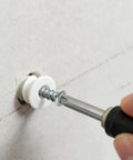 Using Heavy Duty Drywall Anchors And Screws Kit With 100 Self Drilling Plastic Anchors, 100 Size 8 Phillips Screws, And PH2 Bit drilling into wall