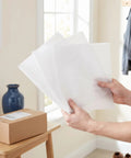 Hands holding Heavy Duty Foam Cushion Pouches For Dishes And Glassware 120 Pack 11.8 by 9.8 Inches Lamination Shielding For Moving