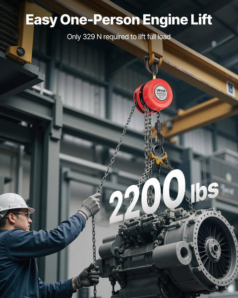 VEVOR hand chain hoist, red, 1-ton capacity with galvanized chain, lifting a large industrial engine in a workshop.