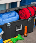 Flex Your Storage Game With Heavy Duty Plastic Footlocker Rolling Bin With Wheels And Handle, Stackable Tote Featuring Secure Latching Lid For Basements Dorms And Shared Spaces, Smooth Operator Hauler Chest In Black storing blue and red blankets with additional gear.
