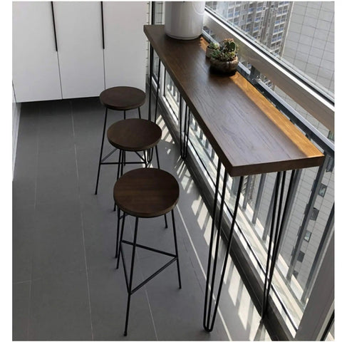 Rock Solid Black Hairpin Table Legs With Adjustable Height And Reinforced Welded Base For Dining Or Coffee Tables Includes Scratch Guard Feet Built Tough To Carry Heavy Loads supporting a wooden tabletop, paired with metal stools.