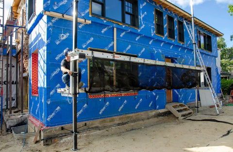 Metaltech Aluminum Pump Jack 2000 installed on a blue-wrap construction site