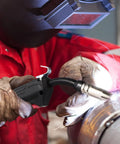 Solid 14k Copper Mig Welding Torch Stinger With Operating Channels That Fits All Standard Wire Sizes in use by a welder.