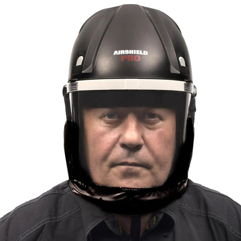 Badass Powered Air Respirator And Hearing Protection Bundle For Woodworking Shops Featuring Full Face Impact Shield Heavy Duty Dust Filters And Integrated Ear Guards Built Tough For Sanding Routing And Turning worn by a man.