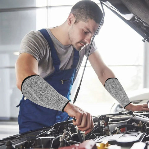 Mechanic wearing Five Pack Cut Resistant Arm Sleeves For Men And Women, Level Five Bite Proof Forearm Guards while working on a car engine