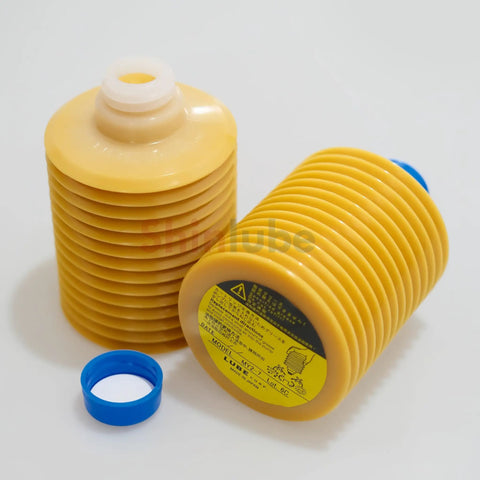 MY2-7 Cartridge Grease 700cc For Sumitomo Injection Molding Machines, mineral and synthetic blend, yellow ribbed cartridge with blue cap.