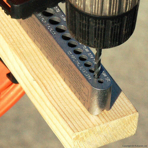 Universal V-Drill Guide for perpendicular hole drilling on flat round and square materials, shown with drill bit in use