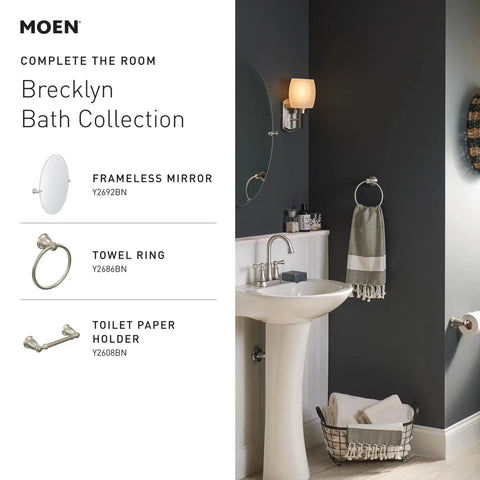 Banbury Pivoting Toilet Paper Holder In Brushed Nickel, shown in a modern bathroom setting with matching accessories.