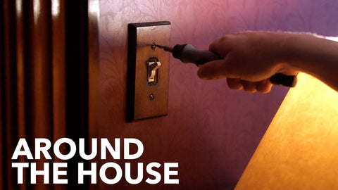 Person using a Cordless Electric Screwdriver With Quick Change Chuck And Six Bits For Quick DIY Screw Fastening to tighten a wall plate.
