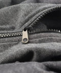 Close-up of a zipper on a gray fabric demonstrating the Six Piece Universal Zipper Repair Kit For Quick Fixes On Clothes Bags And Gear Includes Sliders Top And Bottom Stops Zipper Teeth Design Easy DIY Repair Kit For Fast Zipper Fixes Durable All In One product in use.
