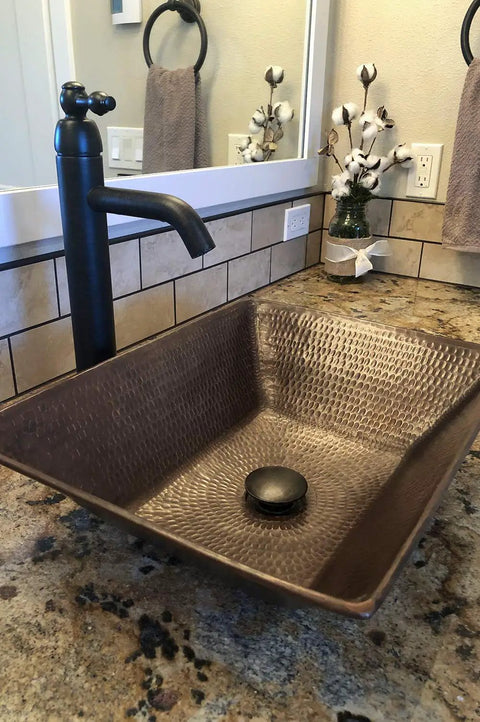 Oil Rubbed Bronze 1.5 Inch Non Overflow Pop Up Bathroom Sink Drain With Push Pop Top Design shown in vanity
