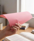Colorful Carbon Tracing Paper Pack for Erasable Transfers on A4 Sheets, Perfect for Wood, Canvas, Embroidery and Crafts, Mess Free, Quick Copy, Ideal for Artists, Designers, and DIY Projects, pink sheet held by hand